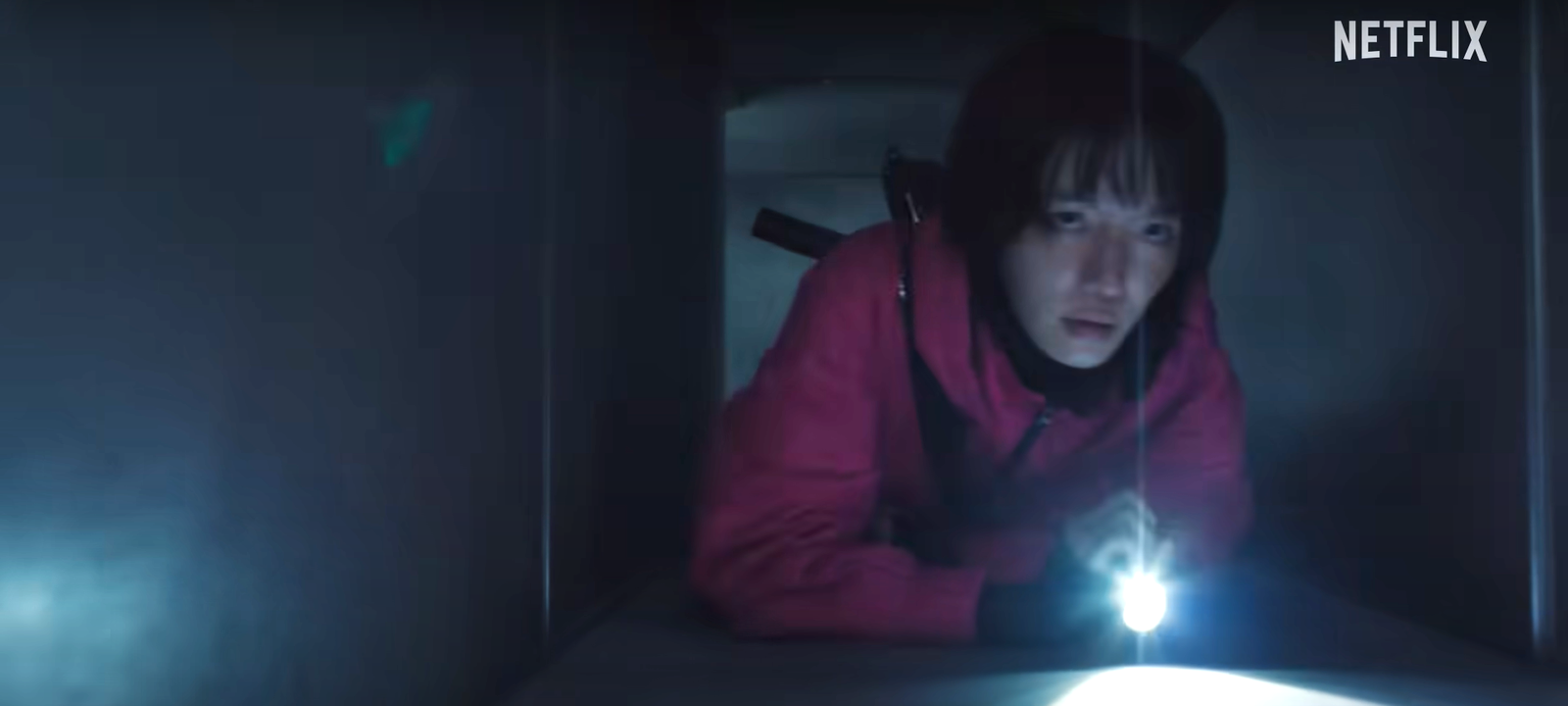Woman guard escaping through the ventilation in Squid Game teaser.