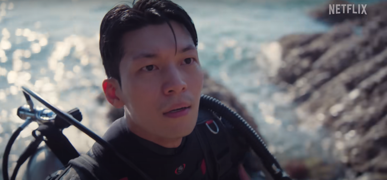 The police officer in diving suit reaching the Squid Game island