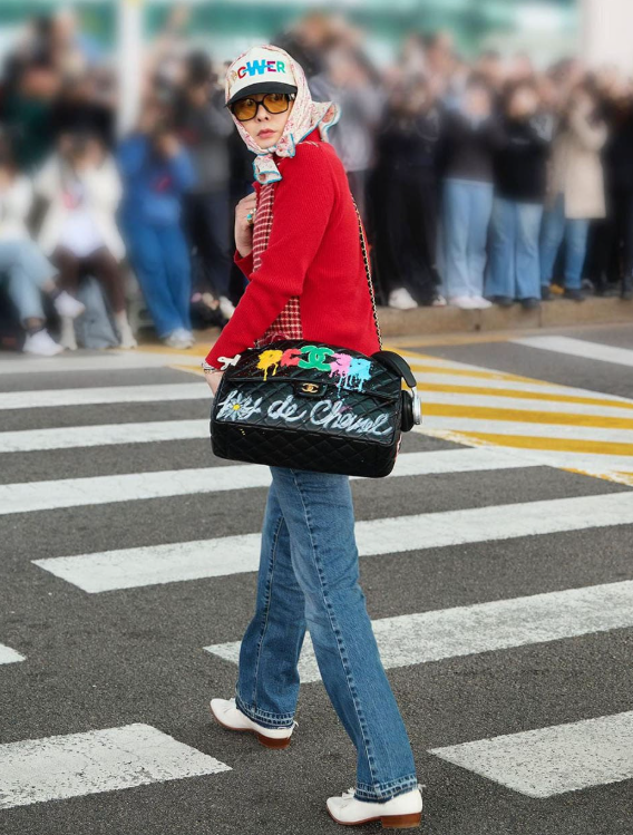The legendary G-Dragon from BIGBANG at the airport, pioneering K-pop fashion with a bold, experimental, and layered outfit.