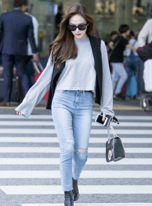 Fashion icon Jessica Jung arriving at the airport, looking sophisticated and chic in a timeless outfit.